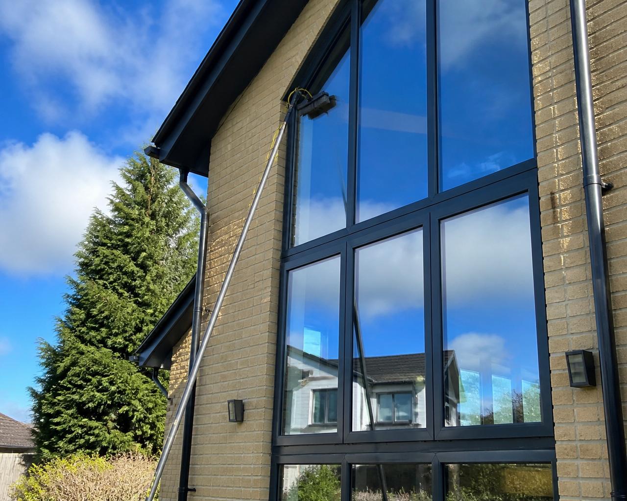 Streak-free exterior window cleaning on a modern South Wales home using a reach-and-pole system